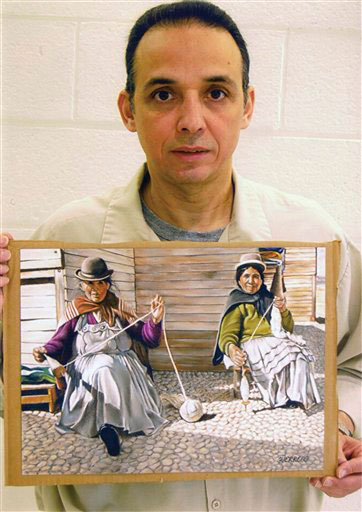 Antonio Guerrero con uno de sus dibujos que representa a dos bolivianas. Foto tomada en la prisión por un guardia de seguridad. (Archivo de Cubadebate)