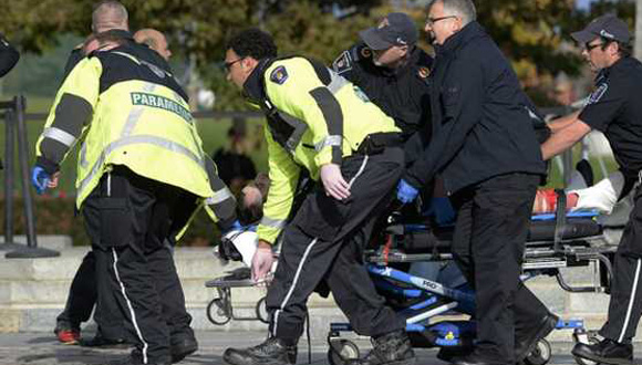 Paramédicos y policías transportan a una víctima del ataque. Foto: EFE. 