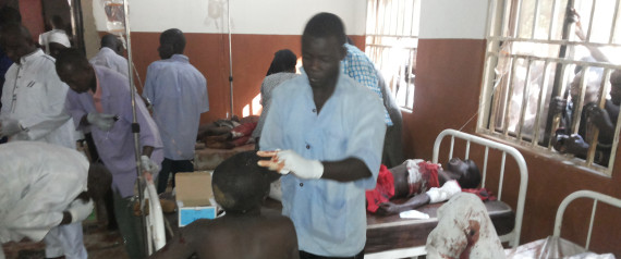 People are treated at the General hospital in Potiskum, Nigeria, Monday, Nov. 10, 2014, following a suicide bomb attack at Government Science Technical College Potiskum. Survivors say a suicide bomber disguised in a school uniform has detonated explosives at a high school assembly in northeast Nigeria, and a morgue worker says 48 students have been killed. (AP Photo/Adamu Adamu)
