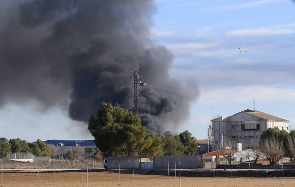 Smoke rises from Los Llanos military base after a plane crash in Albacete, on January 26, 2015. A Greek fighter jet crashed on takeoff at a military airbase in Spain while taking part in NATO exercises Monday, killing 10 people and injuring 13, the defence ministry said.    AFP PHOTO / JOSEMA MORENO