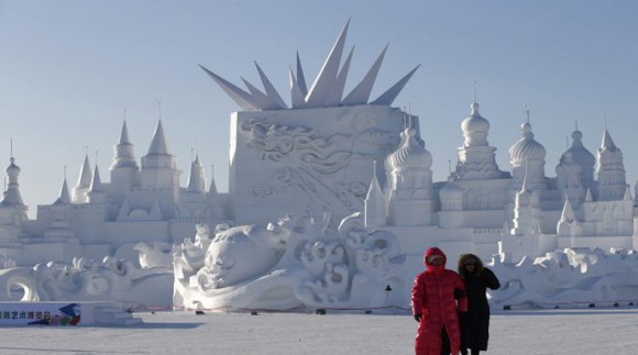 Visitors walk past large snow sculptures during the Harbin International Ice and Snow Festival in the northern city of Harbin