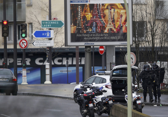 French intervention police are seen at the scene of a hostage taking at a kosher supermarket in eastern Paris