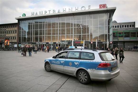 Police car drives past Cologne's main train station of Cologne on Tuesday. OLIVER BERG / DPA via AFP - Getty Images