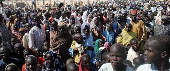 (FILES) This file photo taken on February 2, 2016 shows Internally Displaced Persons (IDP) mostly women and children waiting to be served with food at Dikwa Camp, in Borno State in north-eastern Nigeria. The death toll in a twin suicide bomb attack at a camp for people displaced by Boko Haram's Islamist insurgency has risen to 58, emergency services officials said on February 10. The Borno state emergency management agency had earlier said it recovered 35 bodies from the attack, which happened in Dikwa, some 90 kilometres (55 miles) from the city of Maiduguri, on February 9 morning. / AFP / STRINGER