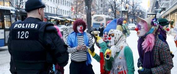 Anti-racist Loldiers of Odin clowns speak with police as they take to the streets against anti-immigration marchers in Tampere, Finland January 23, 2016. Police prevented the groups from confronting each other. On the northern fringes of Europe, Finland has little history of welcoming large numbers of refugees, unlike neighbouring Sweden. But as with other European countries, it is now struggling with a huge increase in asylum seekers and the authorities are wary of any anti-immigrant vigilantism.   REUTERS/Kalle Parkkinen/Lehtikuva    ATTENTION EDITORS - THIS IMAGE WAS PROVIDED BY A THIRD PARTY. FOR EDITORIAL USE ONLY. NOT FOR SALE FOR MARKETING OR ADVERTISING CAMPAIGNS. THIS PICTURE IS DISTRIBUTED EXACTLY AS RECEIVED BY REUTERS, AS A SERVICE TO CLIENTS. NO THIRD PARTY SALES. NOT FOR USE BY REUTERS THIRD PARTY DISTRIBUTORS. FINLAND OUT. NO COMMERCIAL OR EDITORIAL SALES IN FINLAND.