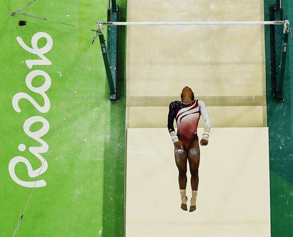 La estadounidense Gabrielle Douglas compite en las barras asimétricas por la final de gimnasia artística. Foto: Morry Gash/ AP.