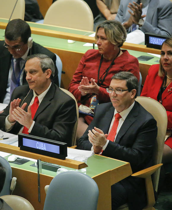 Cuba's Foreign Minister Bruno Rodríguez, right, applaud with his delegation during a meeting of the U.N. General Assembly, Wednesday Oct. 26, 2016 at U.N. headquarters. The United States has abstained for the first time in 25 years on a U.N. resolution condemning America's economic embargo against Cuba, a measure it had always vehemently opposed. (AP Photo/Bebeto Matthews)