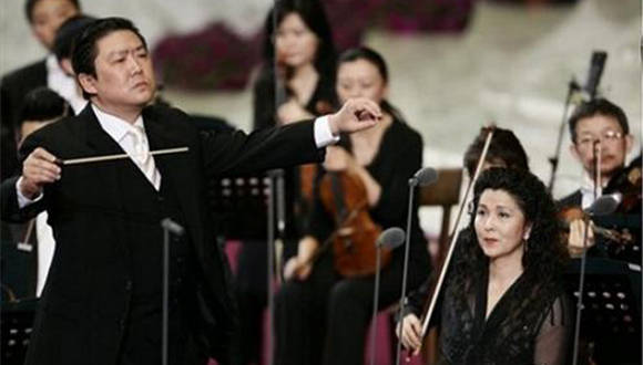 China Philharmonic Orchestra Soprano Lan Rao, at right, looks on as Conductor long Yu performs, at left,  with other members of the orchestra, during a concert in Pope Paul VI hall at the Vatican, Wednesday, May 7, 2008. The China Philharmonic Orchestra performed for the pontiff in a landmark concert Wednesday that could indicate warming relations between Beijing and the Vatican. Benedict called it a "truly unique event" and offered a "thank you" in Chinese at the end of the hour-long concert. (AP Photo/Plinio Lepri)