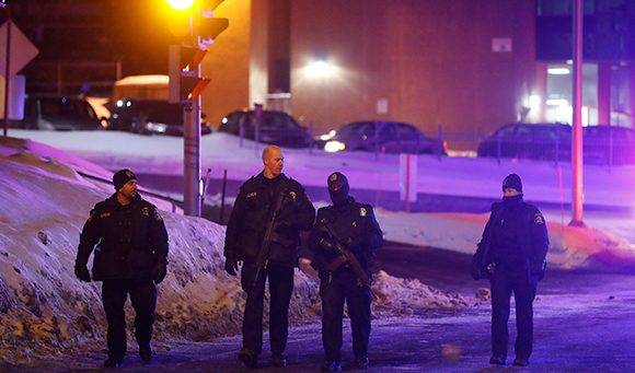 Police officers patrol the perimeter near a mosque after a shooting in Quebec City, January 29, 2017. REUTERS/Mathieu Belanger