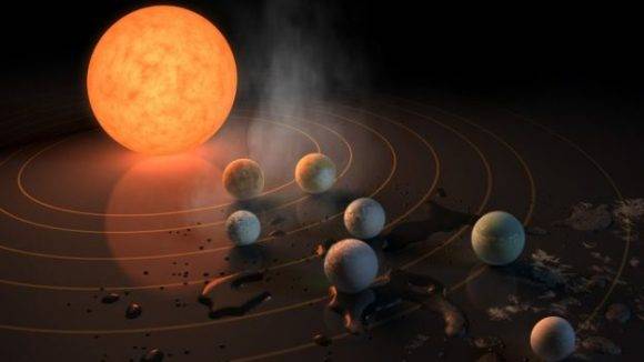 La estrella alrededor de la cual orbitan los siete planetas tiene una luz 2.000 veces más tenue que la de nuestro Sol. Foto: NASA.