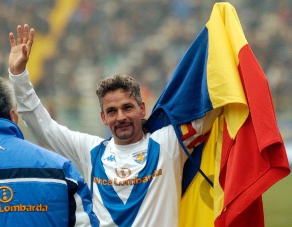 Brescia soccer star Roberto Baggio celebrates after scoring during the Italian first division soccer match between Parma and Brescia at the Tardini stadium in Parma, Italy, Sunday, March 14, 2004. Baggio scored his 200th goal. (AP Photo/Marco vasini)