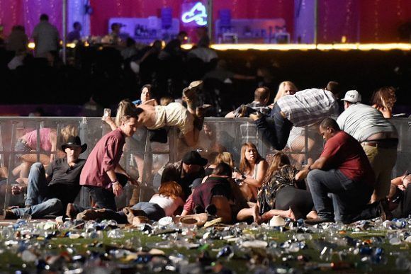 LAS VEGAS, NV - OCTOBER 01:  People run from the Route 91 Harvest country music festival after apparent gun fire was heard on October 1, 2017 in Las Vegas, Nevada.  (Photo by David Becker/Getty Images)