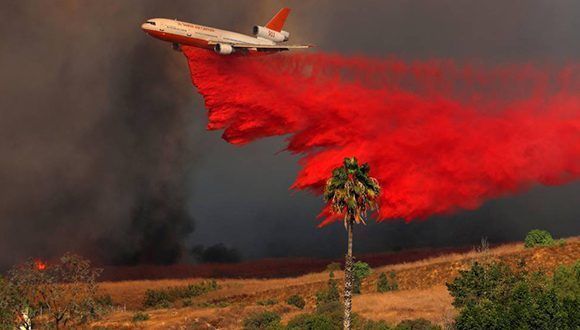 Un avión DC-10 deposita un compuesto retardante de fuego para evitar que el incendio vaya a más en el condado de Orange (California). Foto: Mike Blake / REUTERS