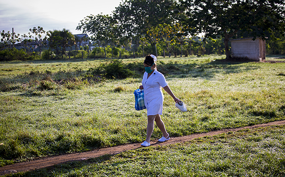 Una enfermera atraviesa un terreno de pelota improvisado para llegar al hospital provincial Comandante Pinares en San Cristóbal, Artemisa. Foto: Irene Pérez/ Cubadebate.