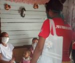 Trabajadora social visita a madre de varios niños durante la pandemia. Foto: tomada de Adelante.